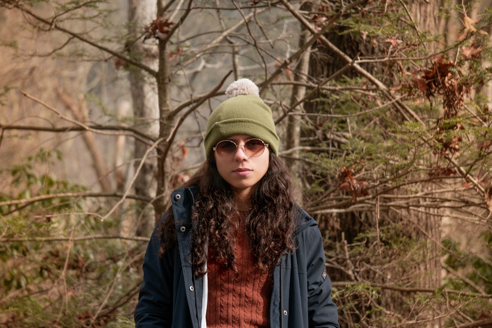 a woman wearing a green hat and sunglasses