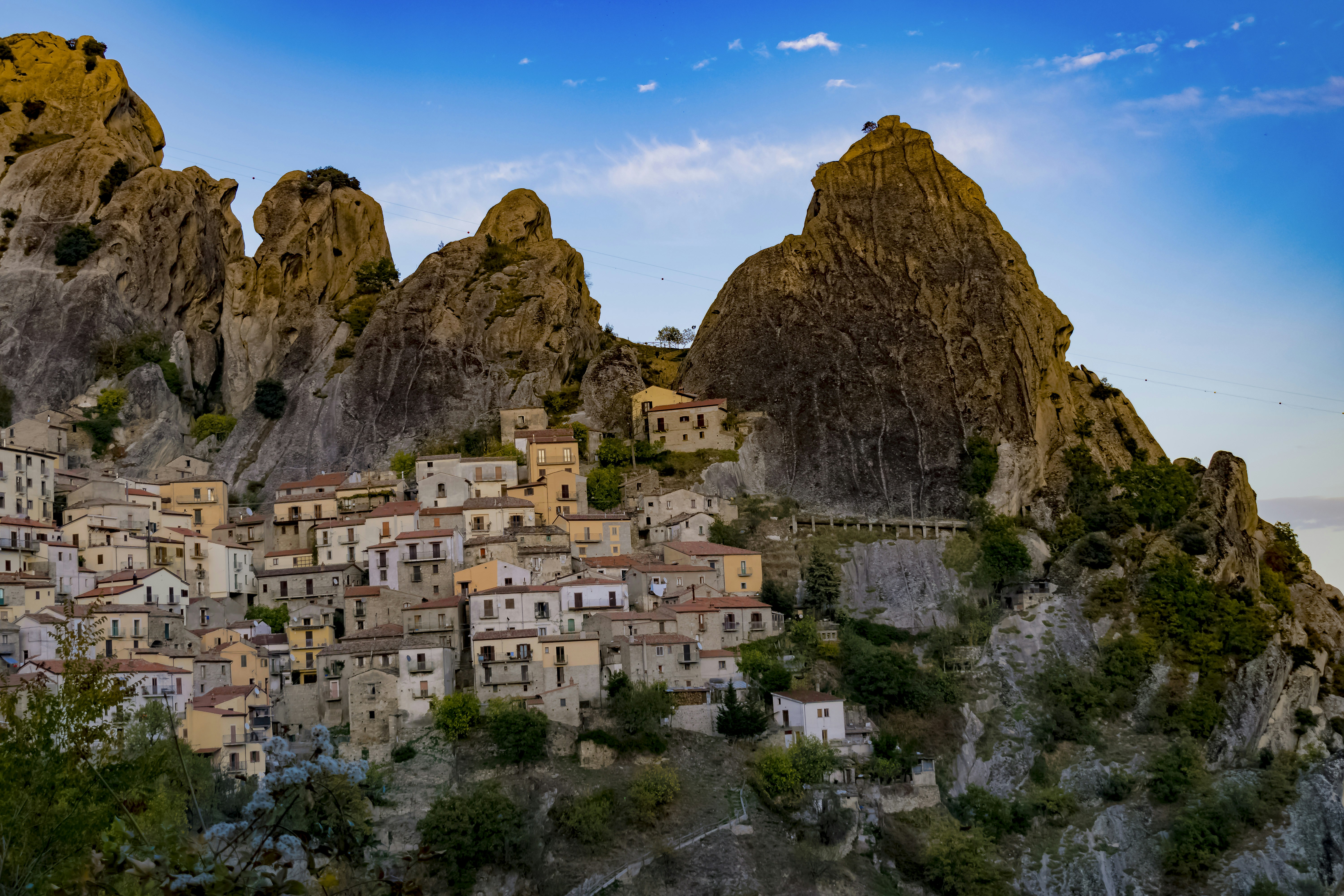a small village nestled on a mountain side, 