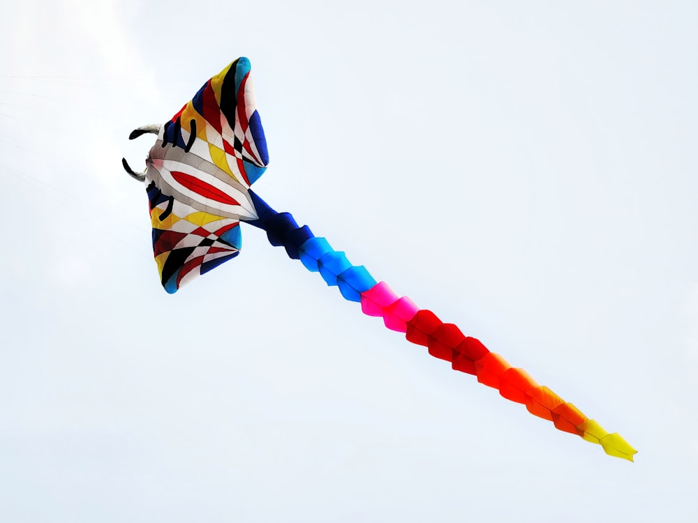 a colorful kite is flying in the sky