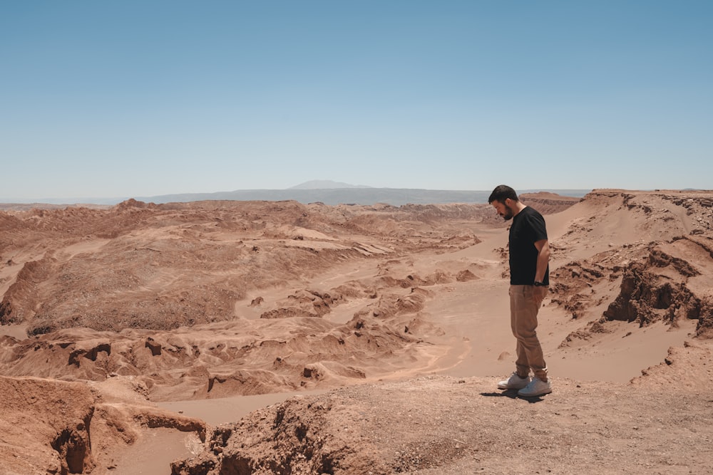 a man standing in the middle of a desert