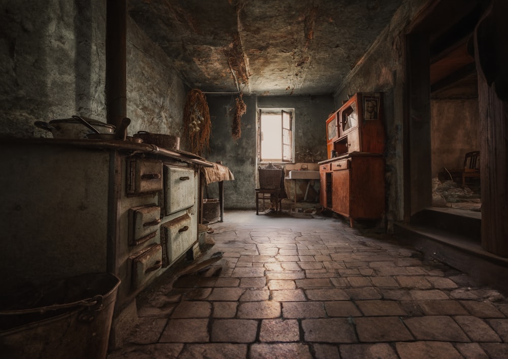 a room with a brick floor and a window