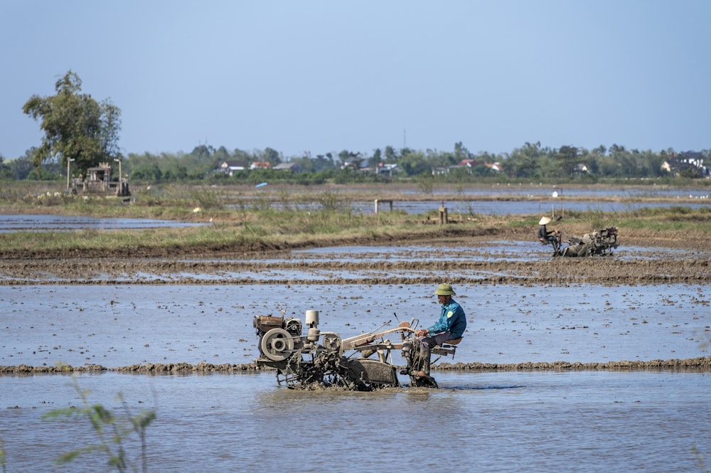 a man is plowing a field with a tractor