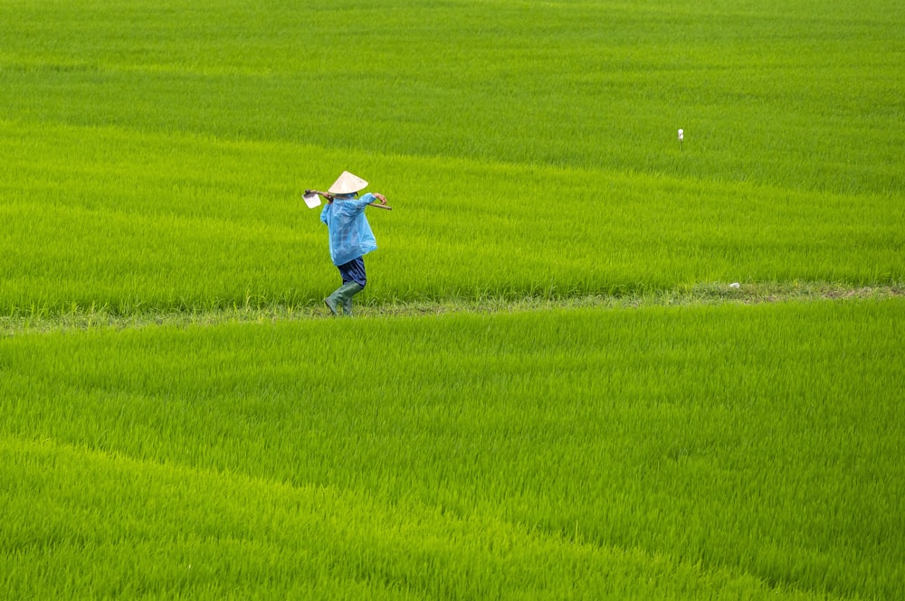 a person in a field with a hat on