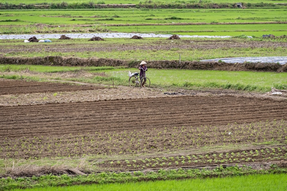 a person on a bike in a field