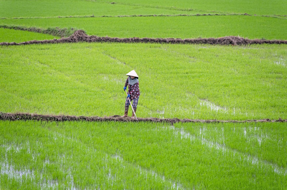 a person standing in a field with a hat on