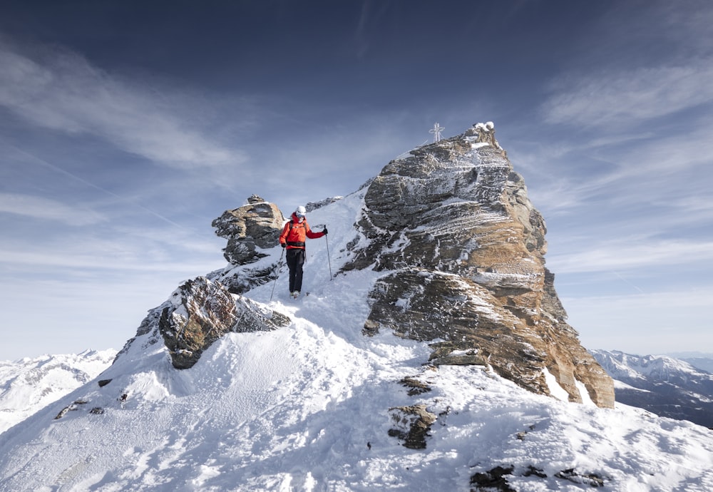 a man standing on top of a snow covered mountain