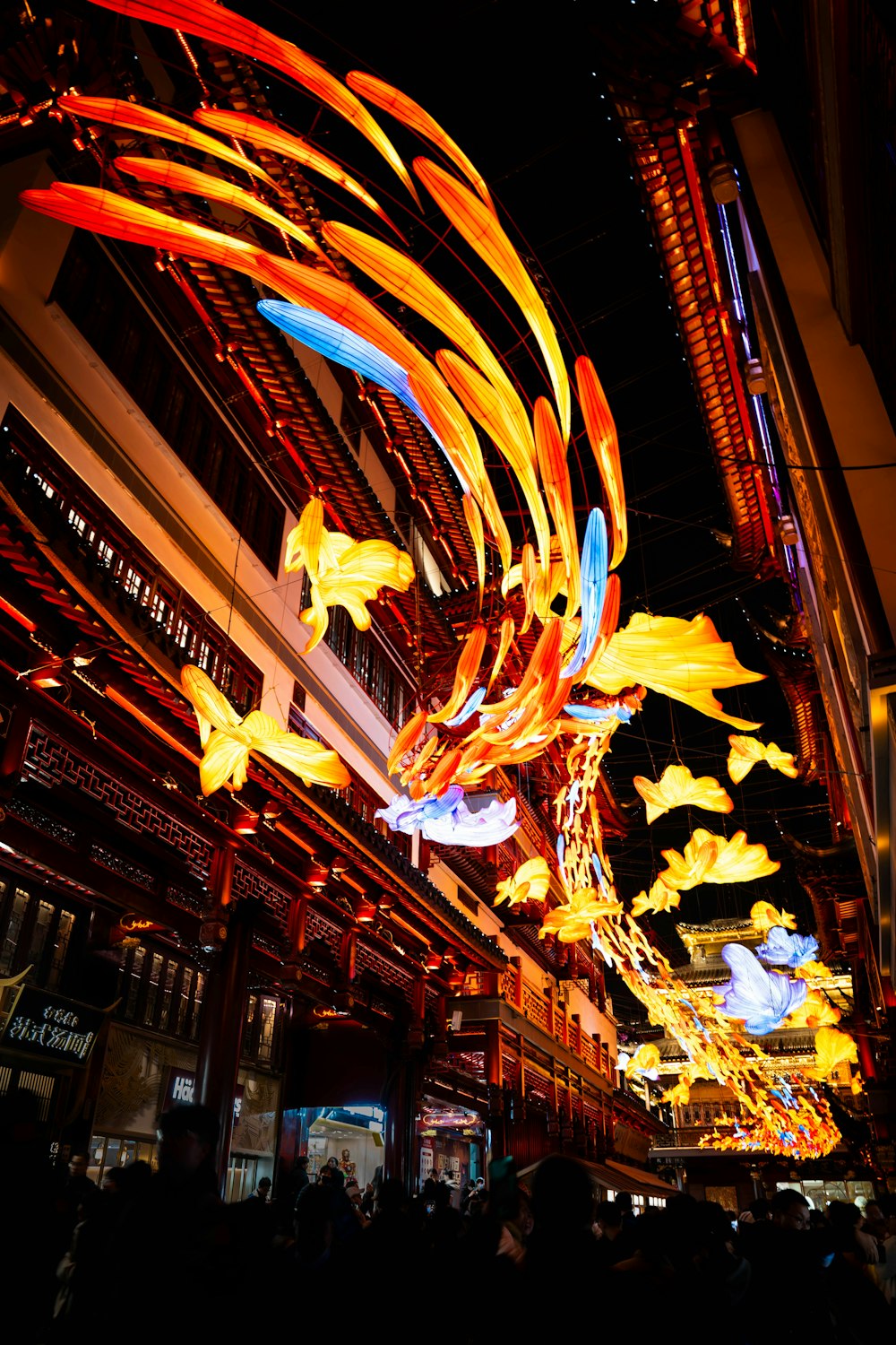 a group of colorful lights hanging from the ceiling of a building