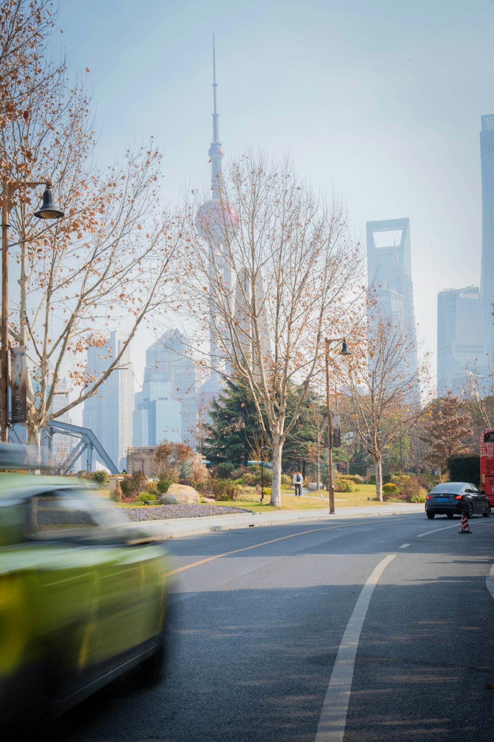 a car driving down a street next to tall buildings