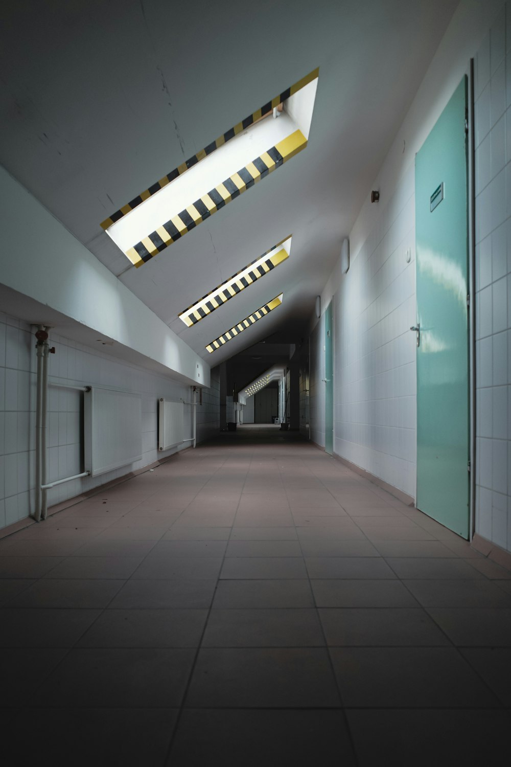 a long hallway with a skylight above it