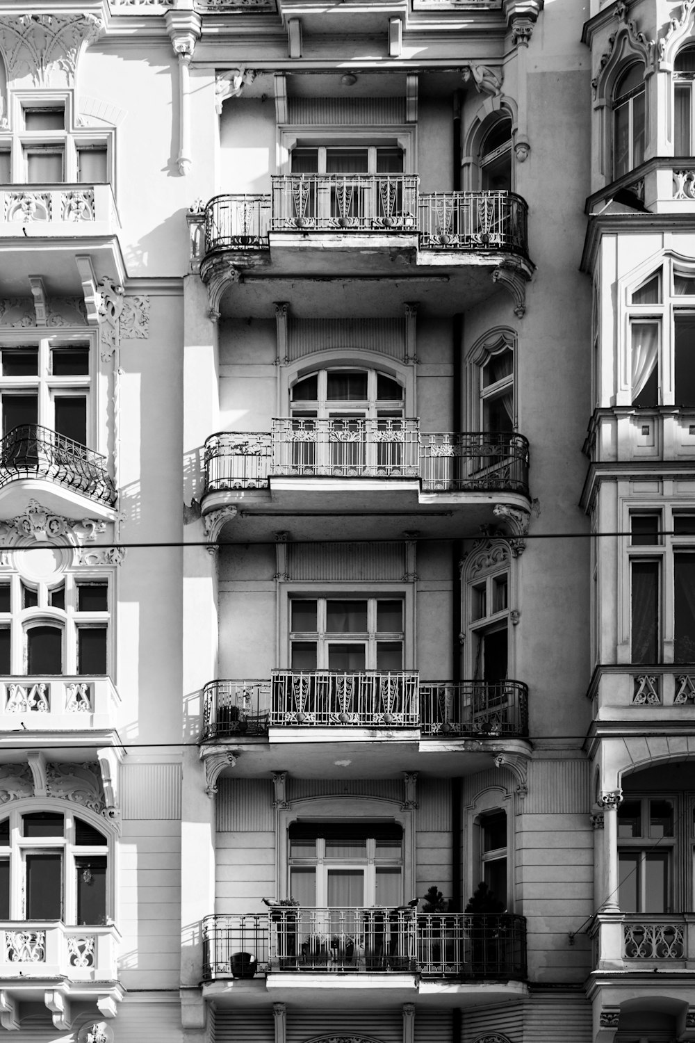 a black and white photo of a building with balconies