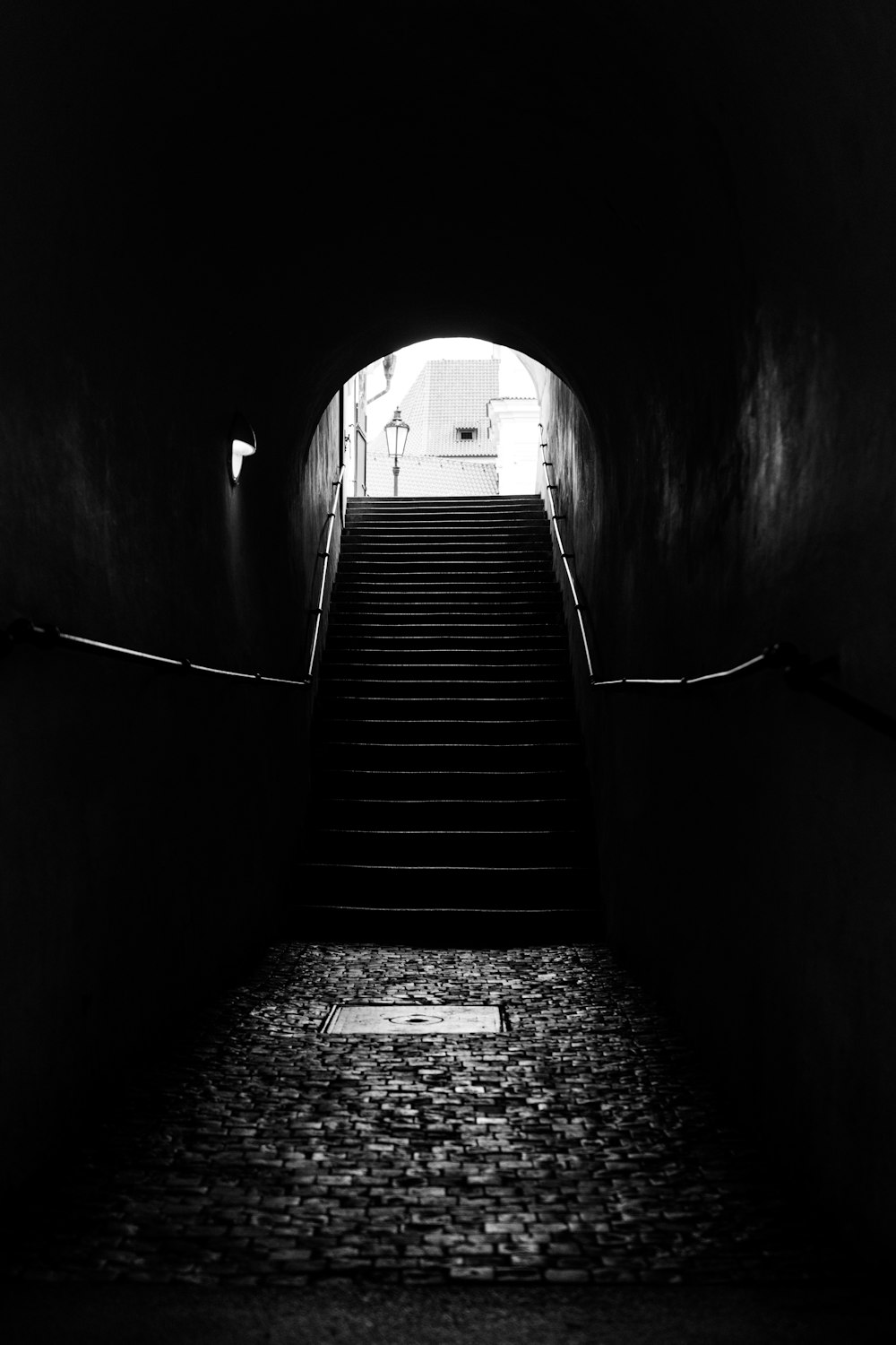 a dark tunnel with stairs leading up to it