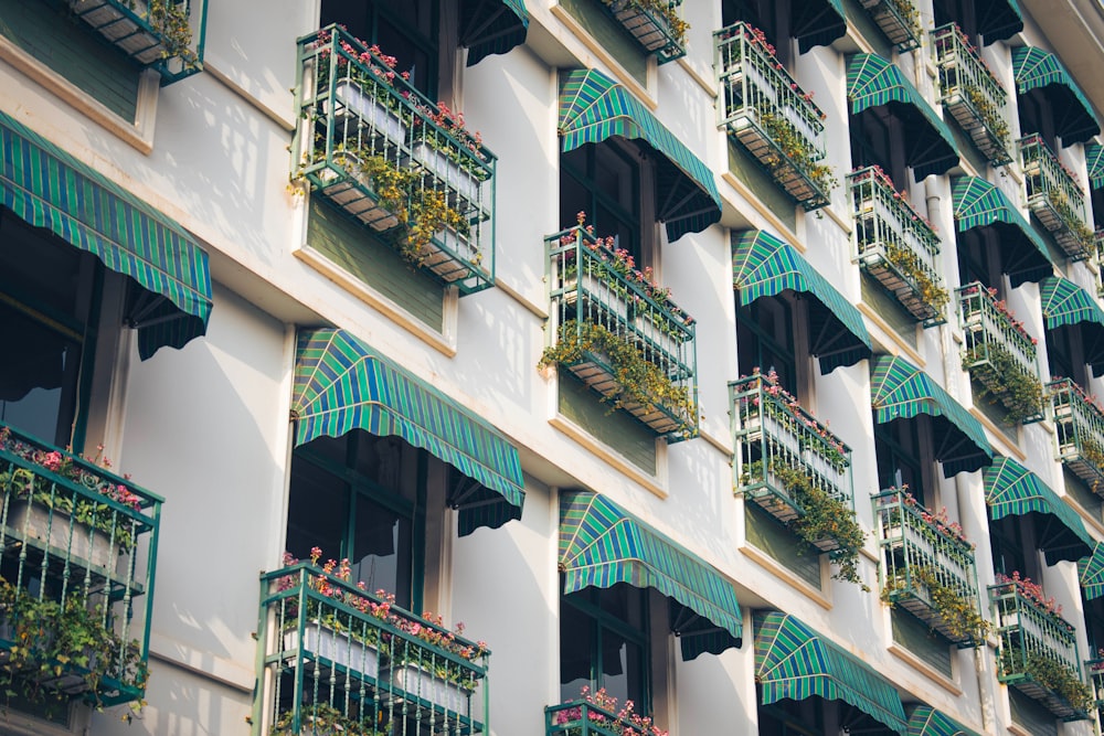 a building with many balconies and flowers on the balconies