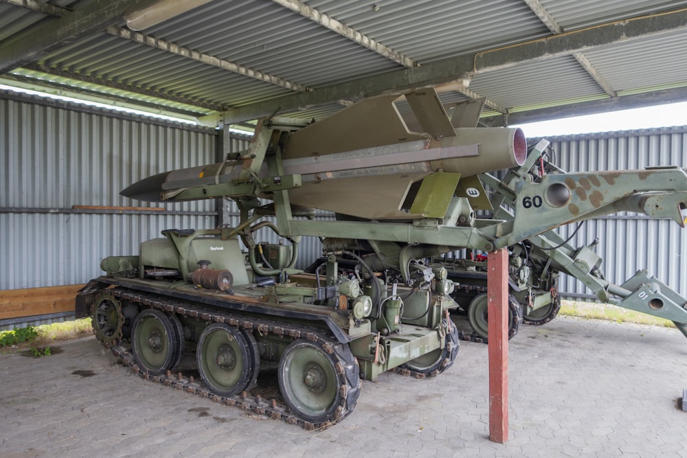 a military vehicle is parked in a garage