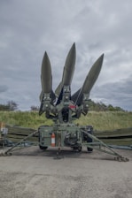 a group of missiles sitting on top of a field