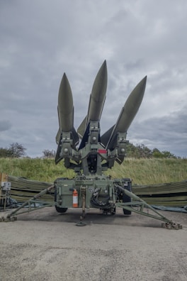 a group of missiles sitting on top of a field
