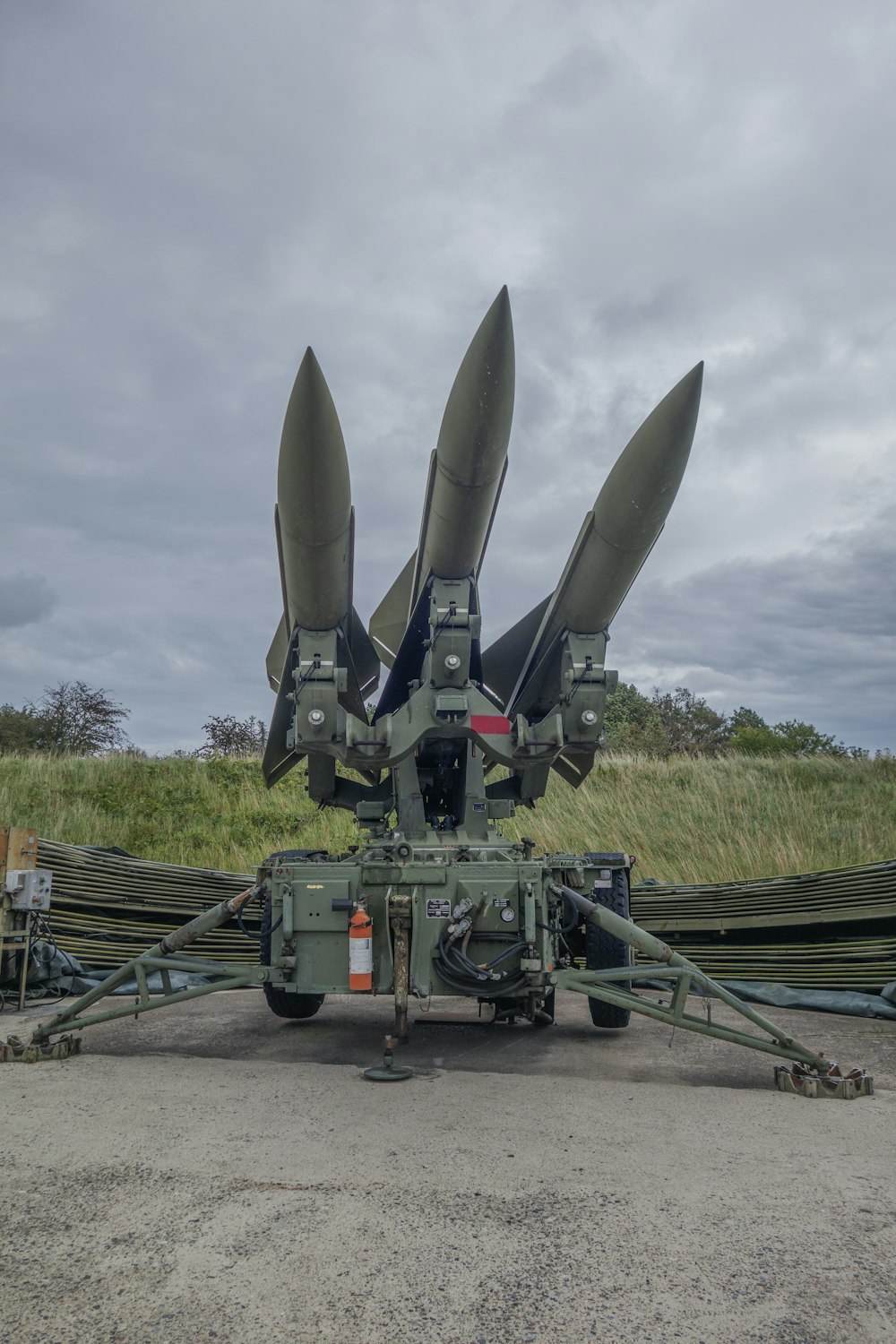 a group of missiles sitting on top of a field