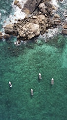 a group of boats floating on top of a body of water
