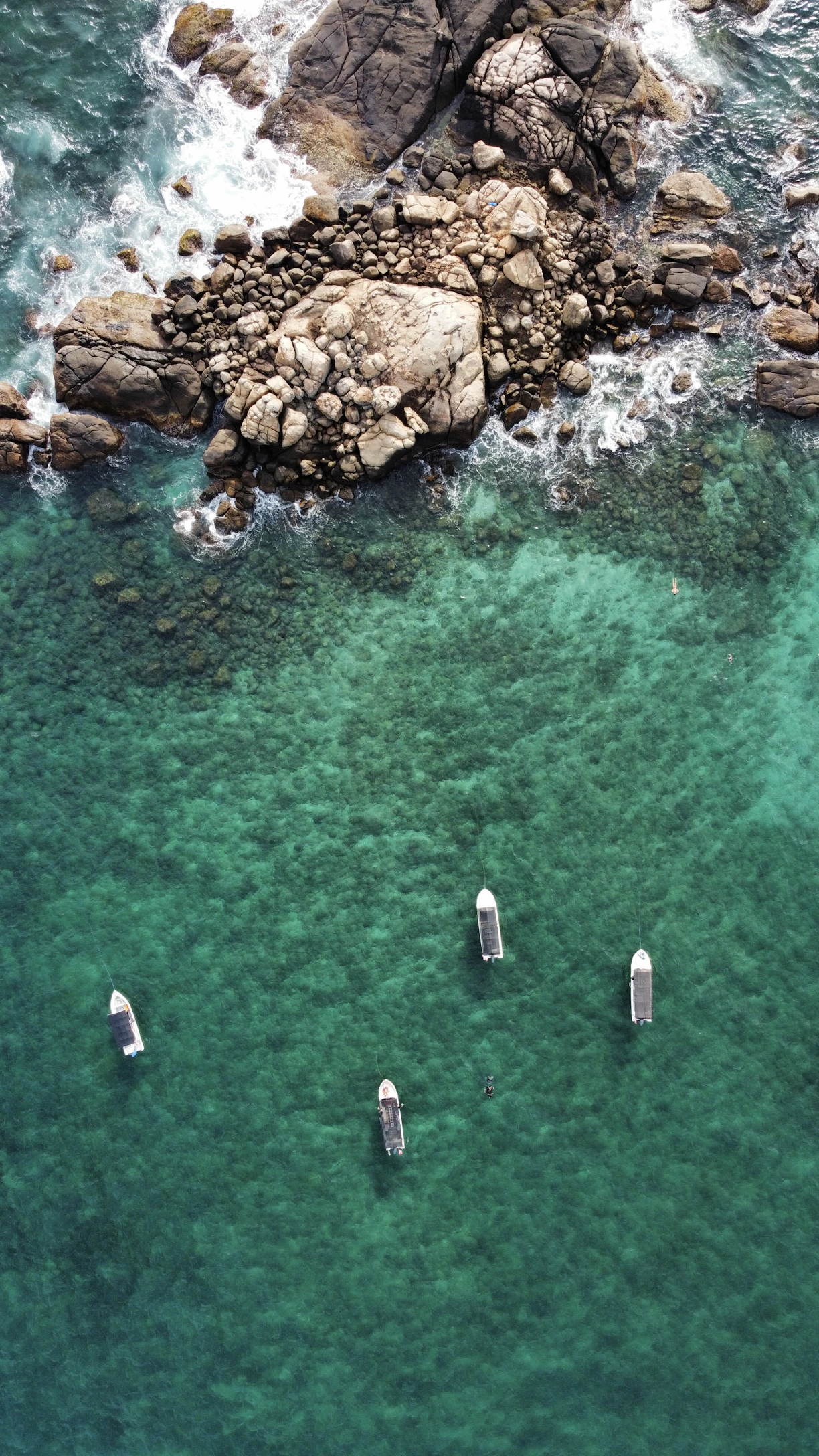 a group of boats floating on top of a body of water