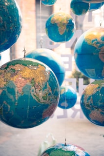 a group of blue and yellow globes hanging from strings