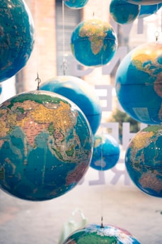 a group of blue and yellow globes hanging from strings