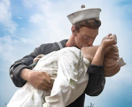 a statue of a sailor holding a baby
