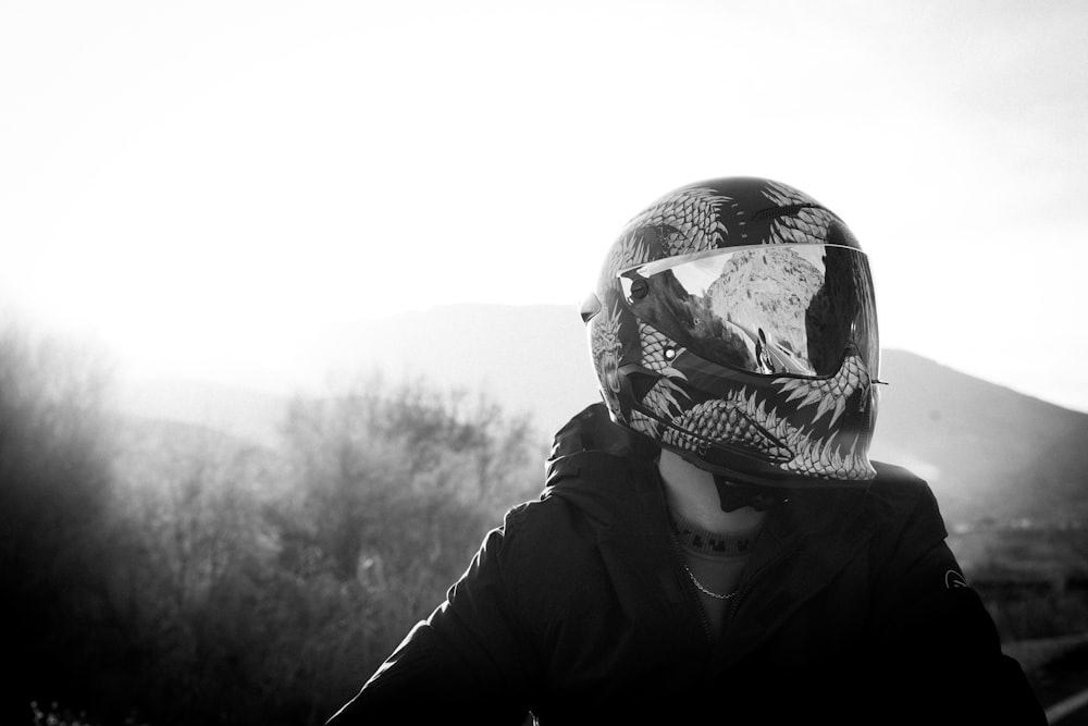 a person wearing a motorcycle helmet with a bird on it