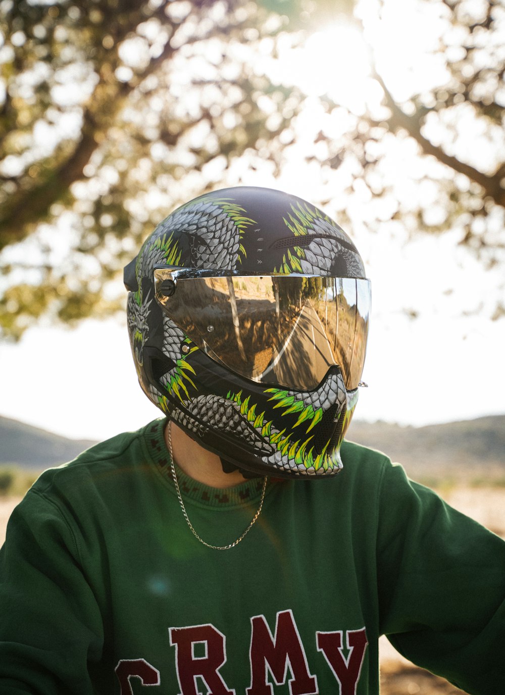 a person wearing a helmet and a green shirt