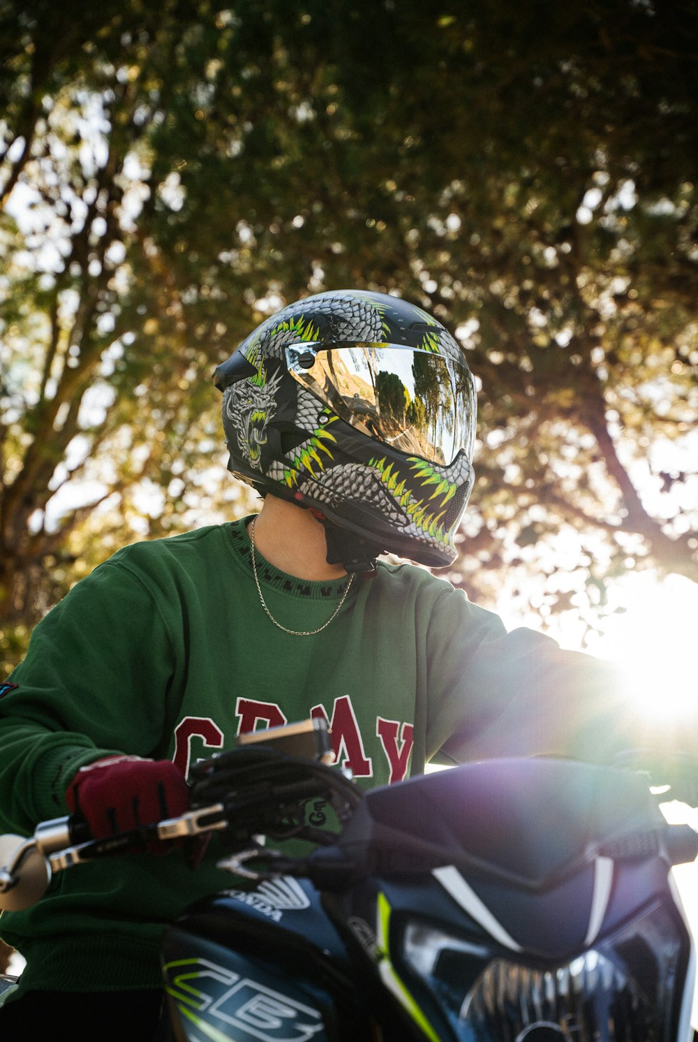 a person wearing a helmet and gloves on a motorcycle