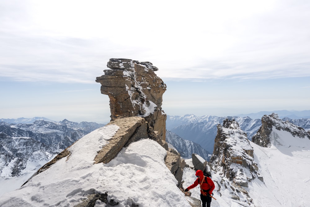 a man standing on top of a snow covered mountain