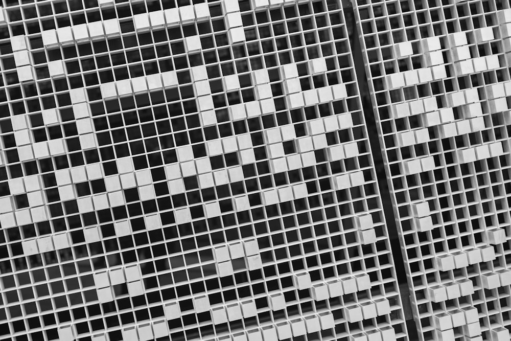 a black and white photo of a cross on a wall