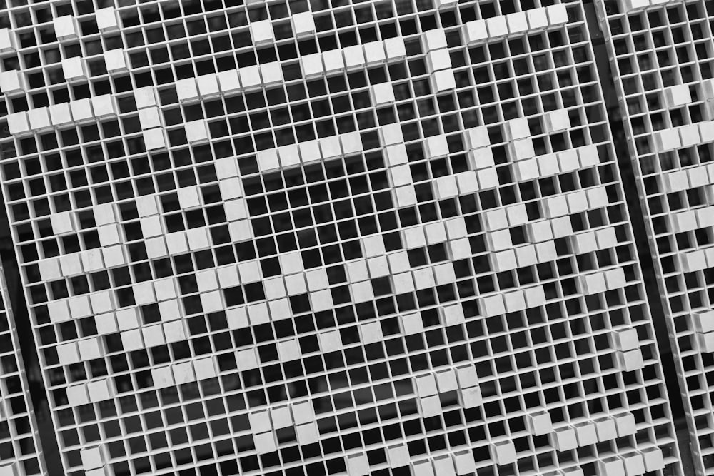 a black and white photo of a cross on a building