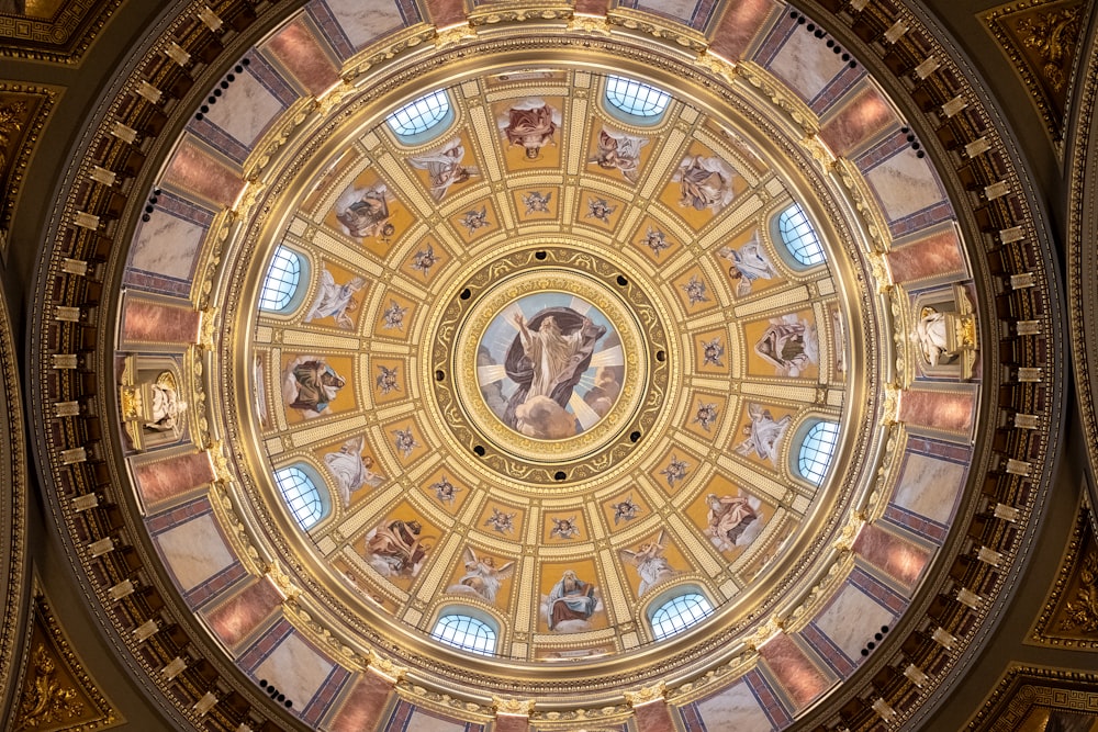 the ceiling of a building with a painting on it