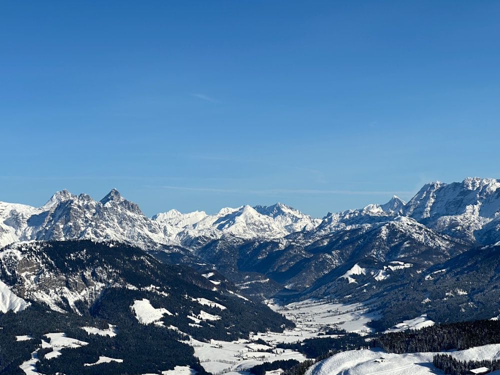 a view of a mountain range with snow on it