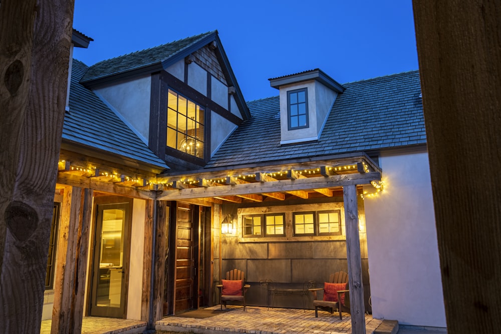 a house with a covered patio with lights on it