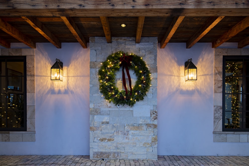 a christmas wreath on the wall of a house