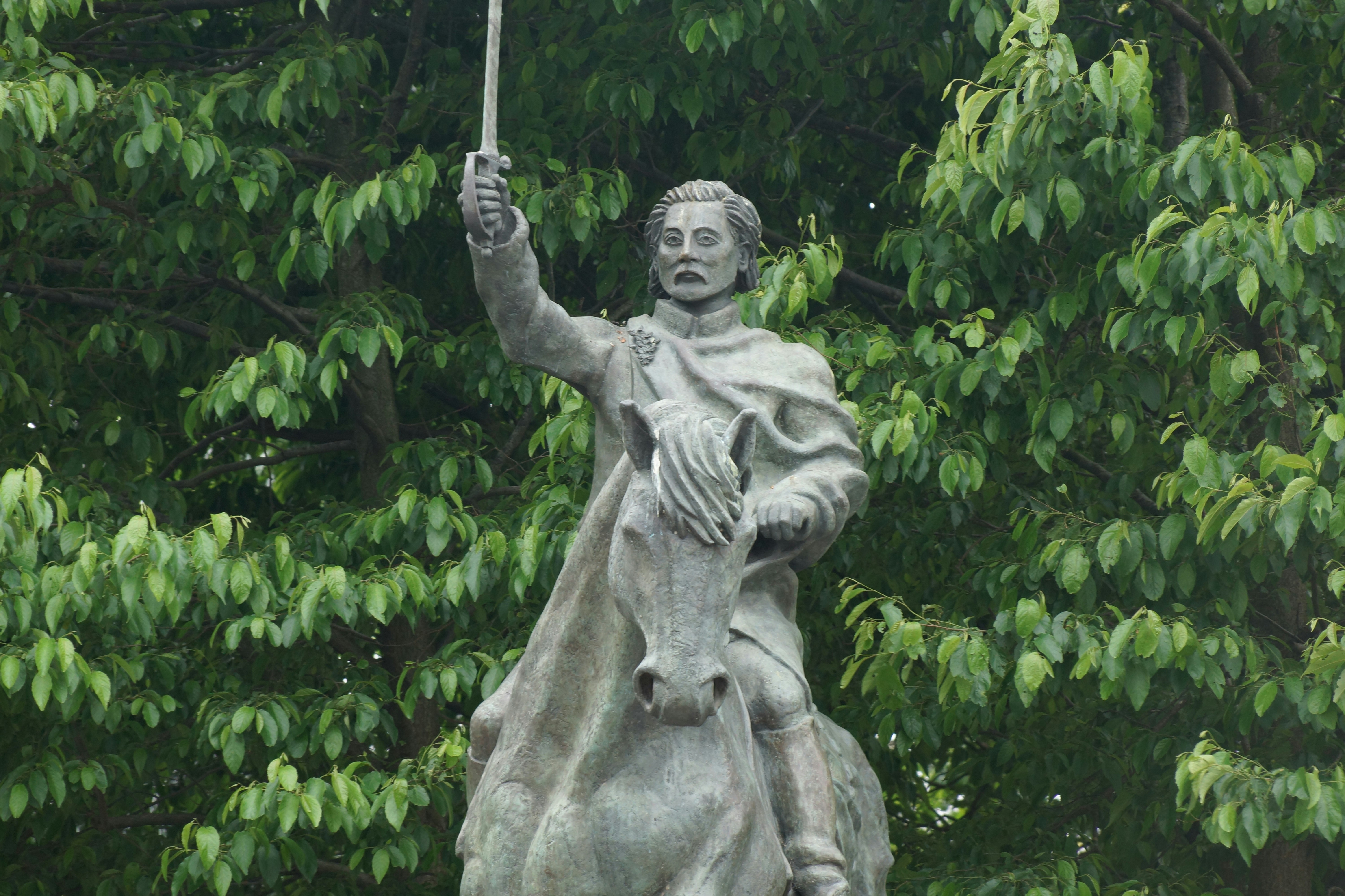 a statue of a woman holding an umbrella