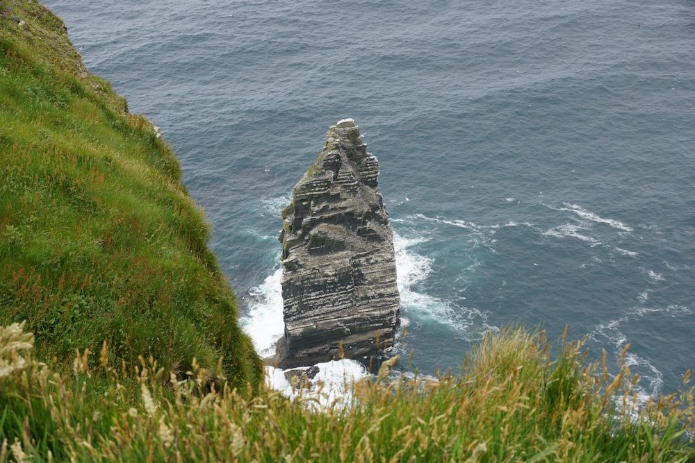 a large rock sticking out of the ocean