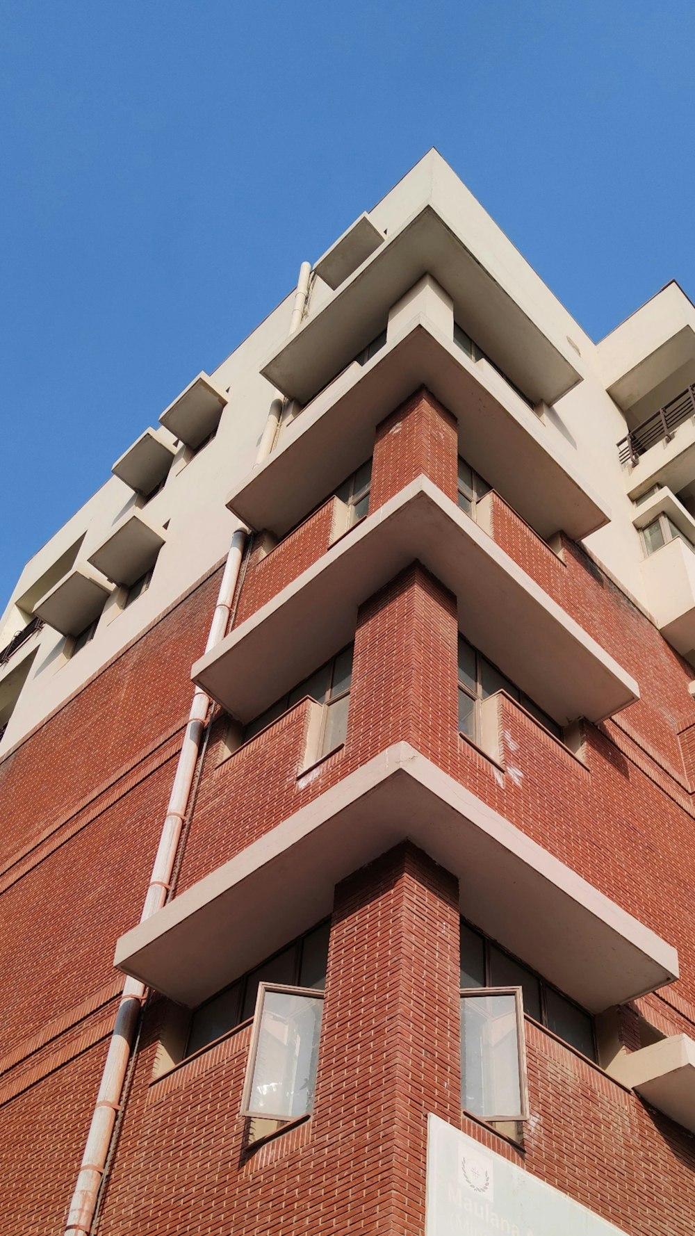 a tall red brick building with lots of windows