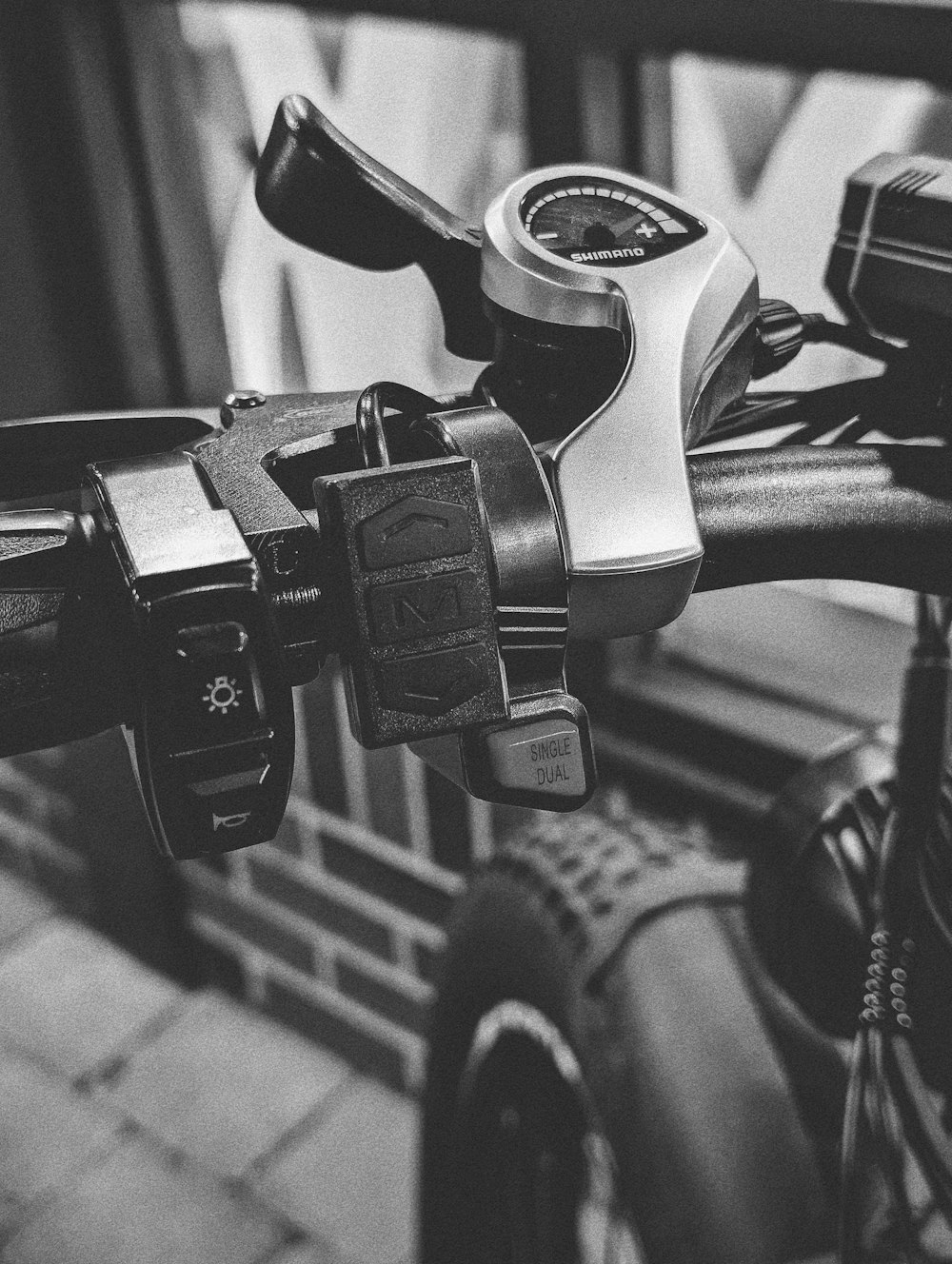 a close up of a bike handlebar with a clock on it