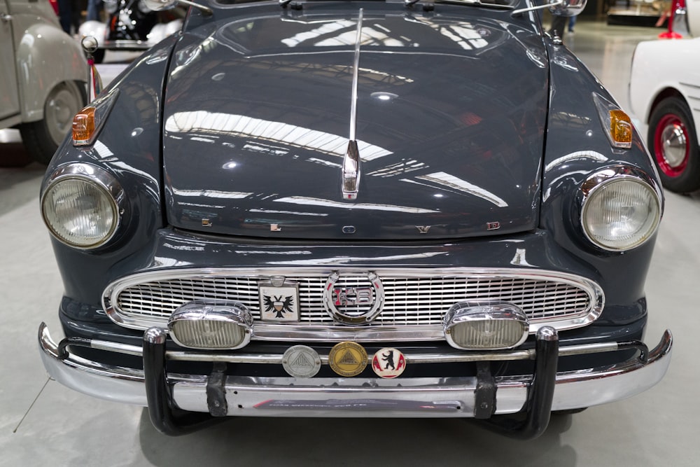 a classic car is parked in a showroom