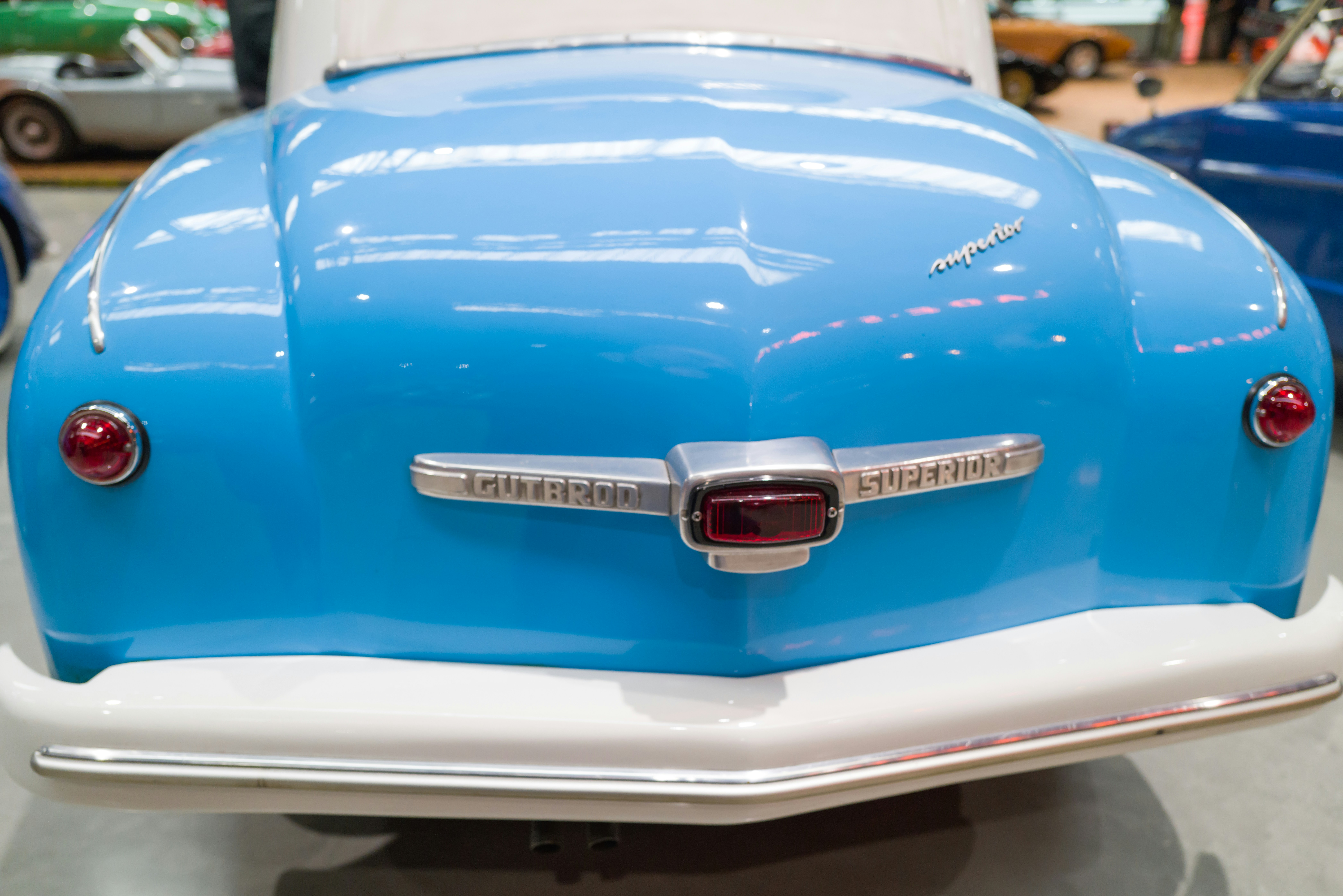 a close up of a blue and white car