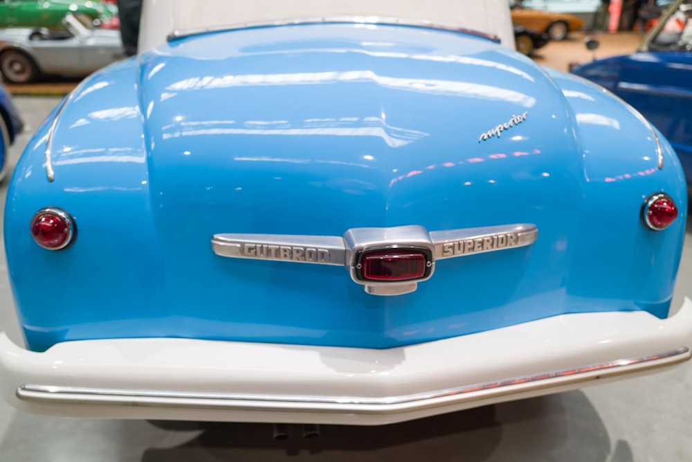 a close up of a blue and white car