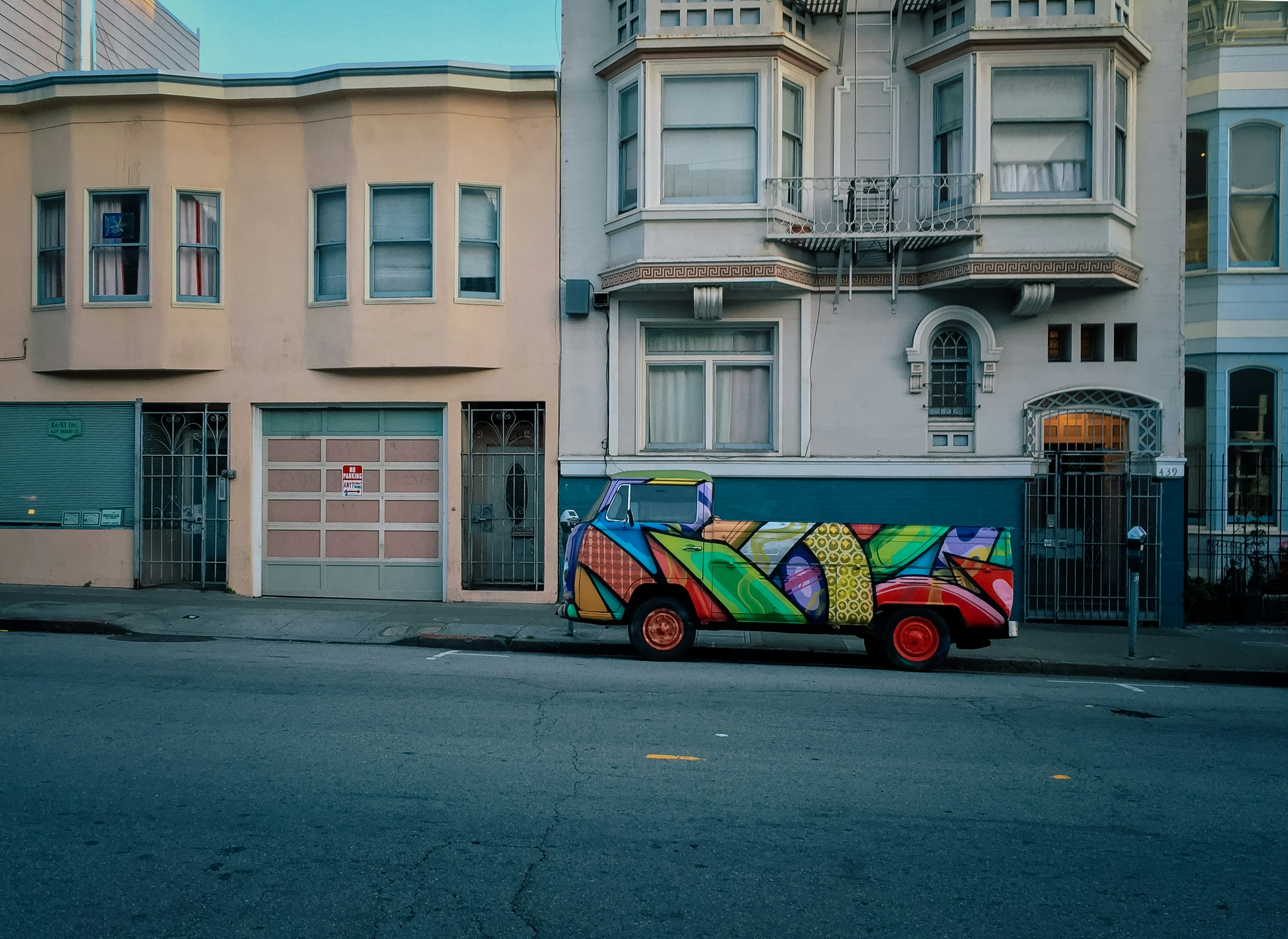 a colorful car parked on the side of the road