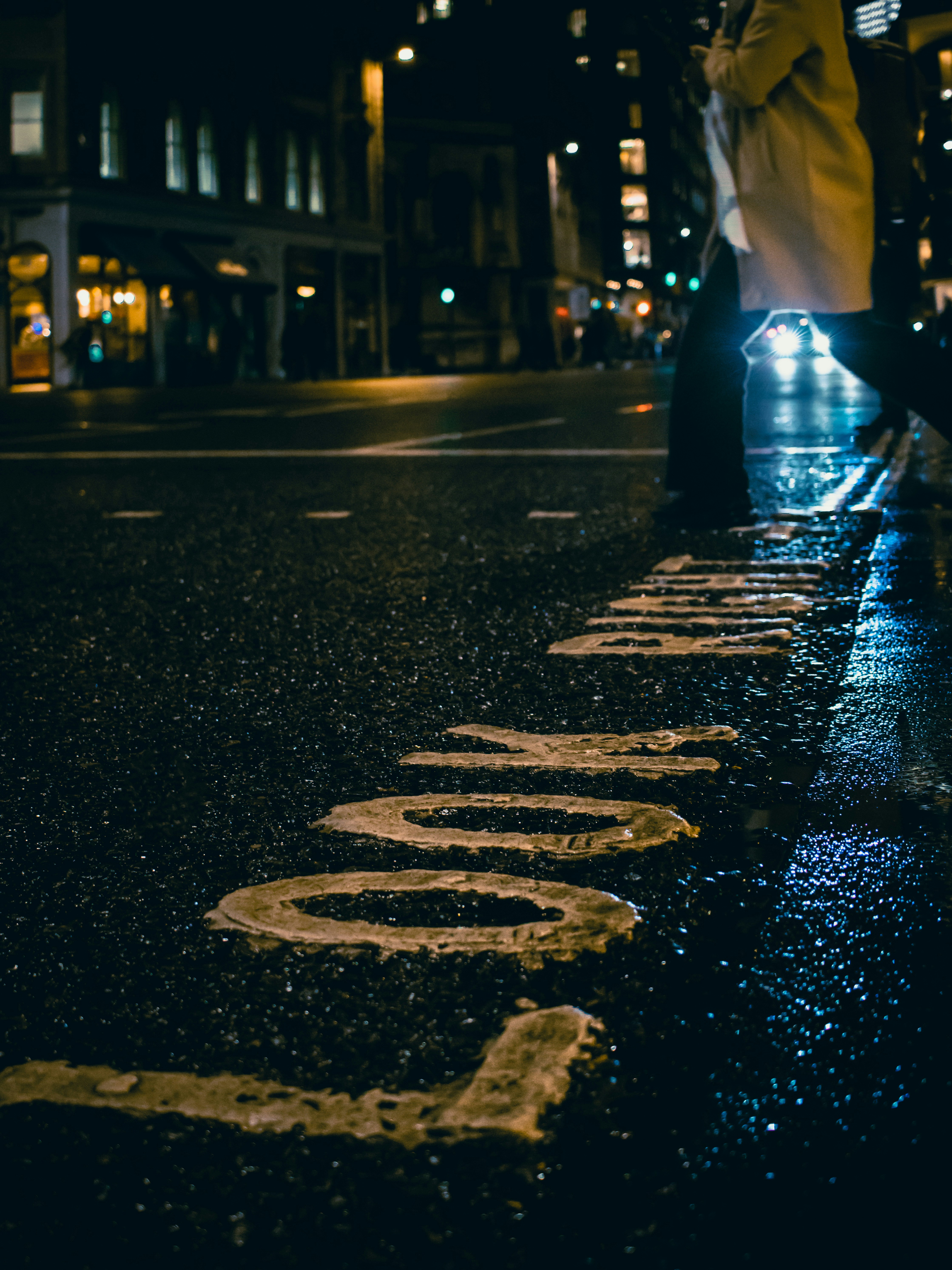 a person walking down a street at night