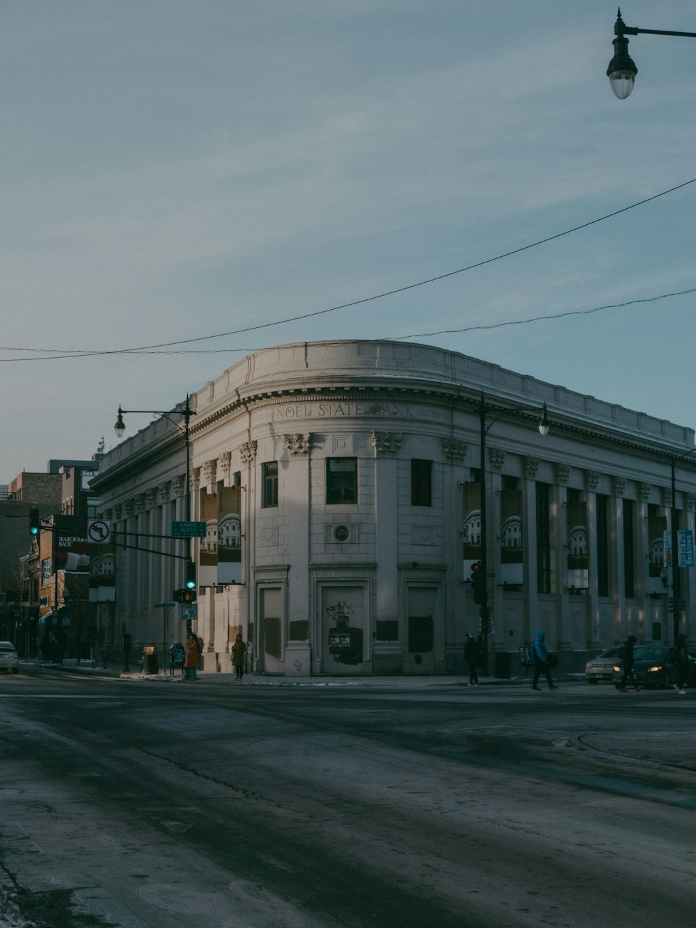 a large white building sitting on the side of a road