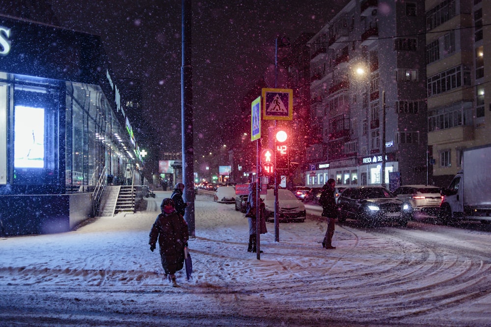 a person walking across a snow covered street