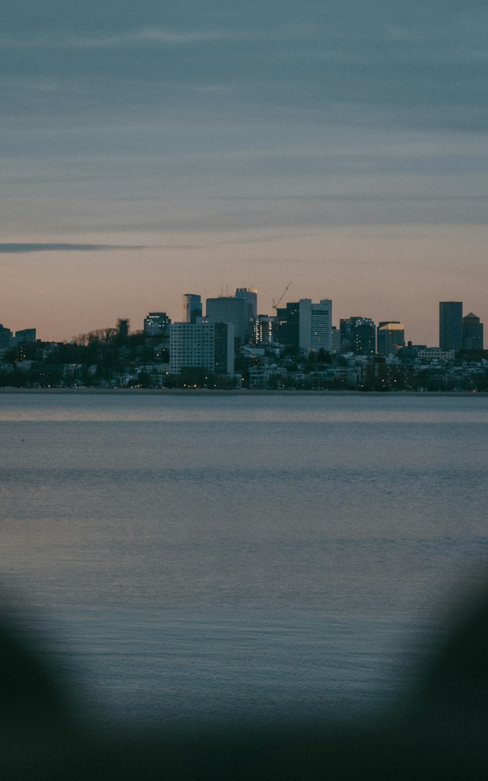 a large body of water with a city in the background