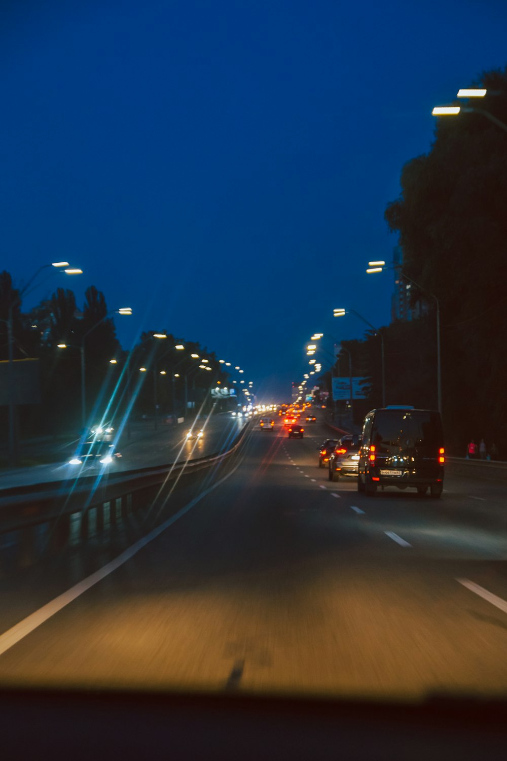 a car driving down a street at night