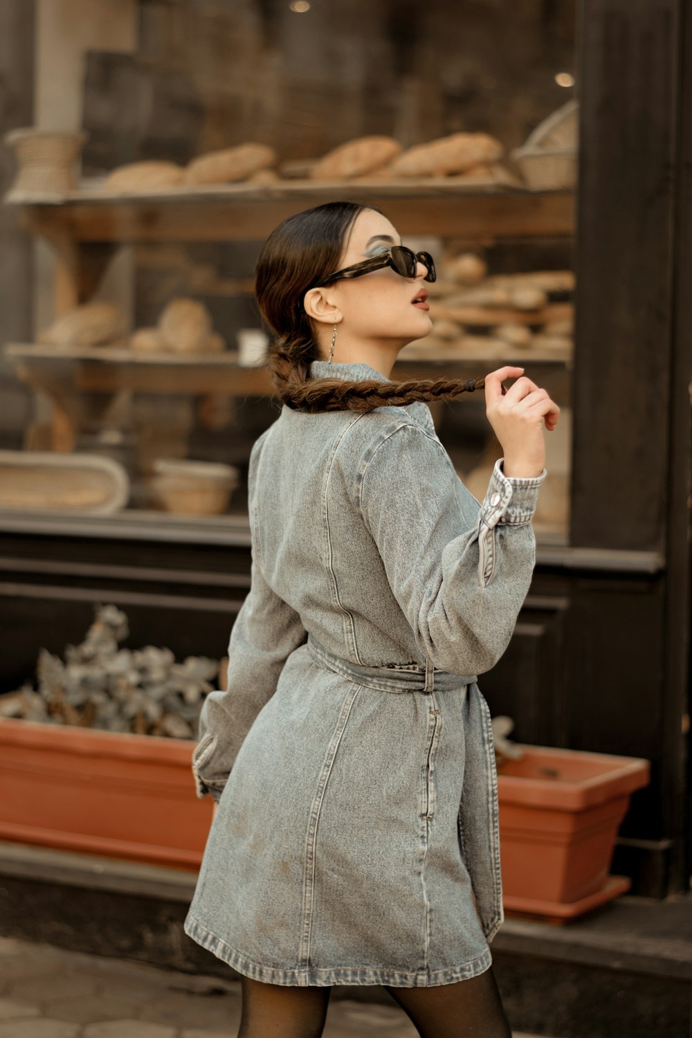 a woman in a gray coat and black tights