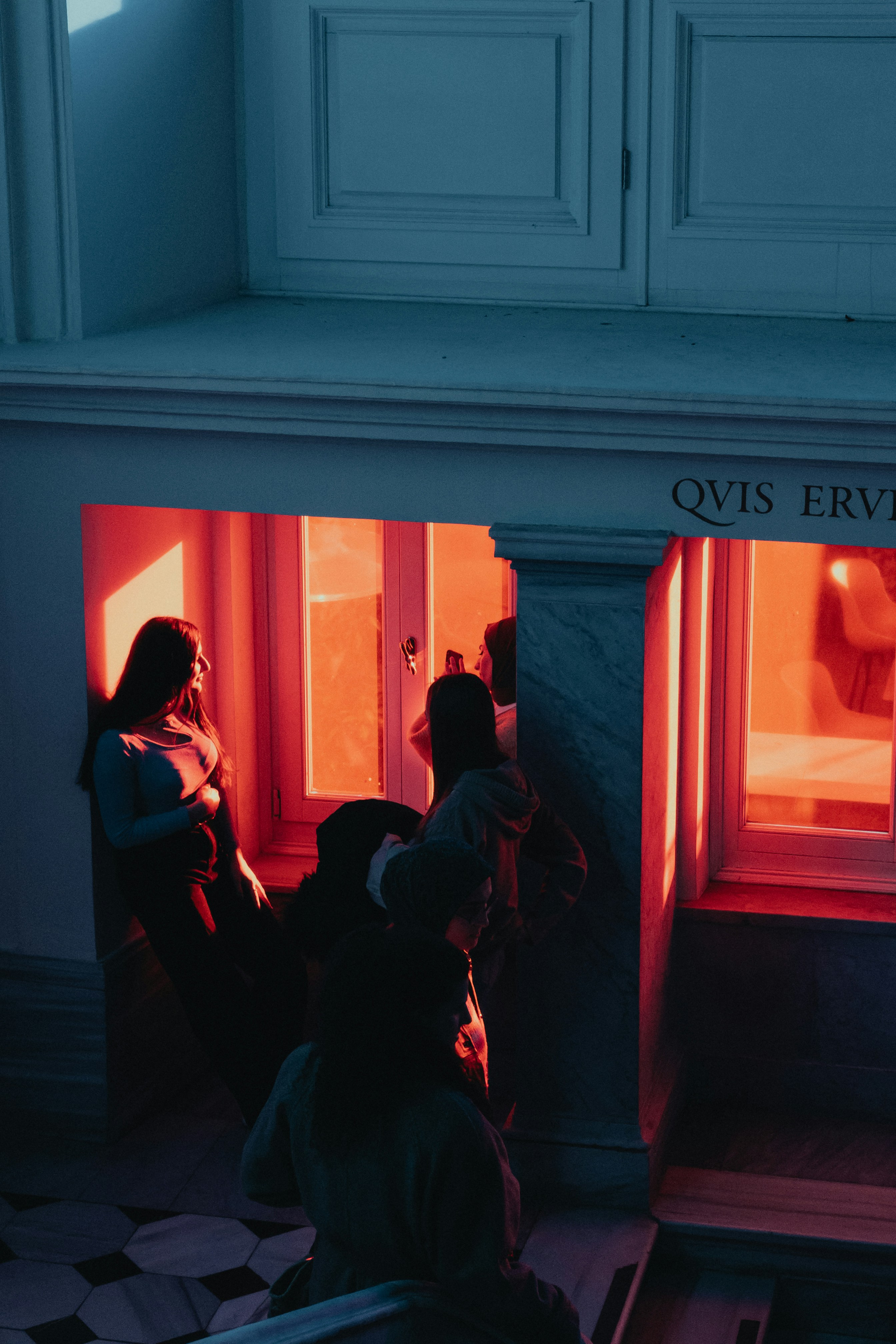 A couple of people sitting in front of a window photo – Free Street ...
